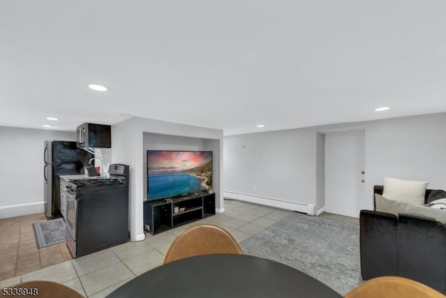 living room featuring light tile patterned flooring and a baseboard heating unit