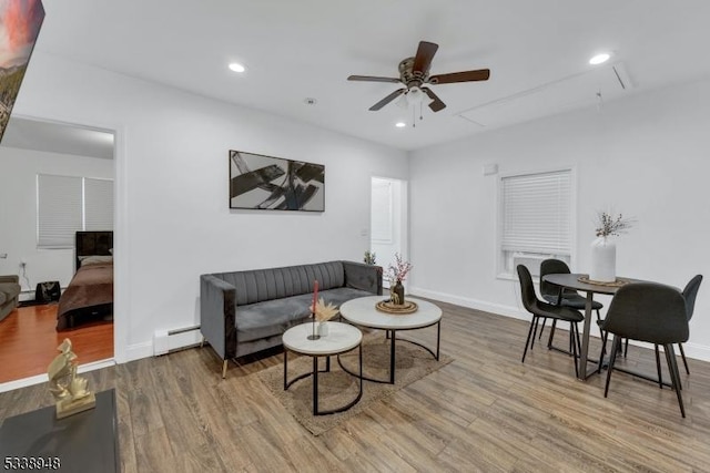 living room with ceiling fan, a baseboard radiator, and hardwood / wood-style floors