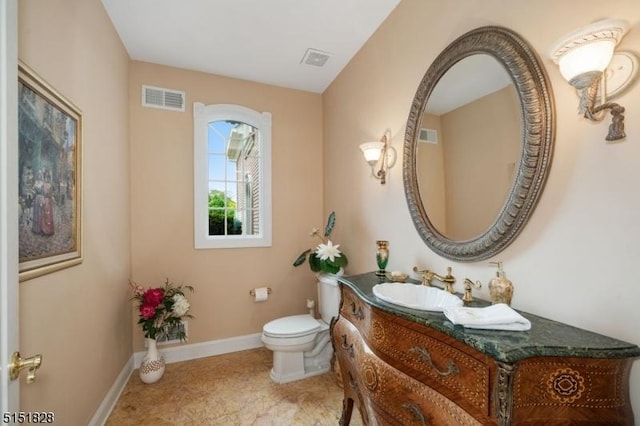 bathroom featuring baseboards, visible vents, vanity, and toilet