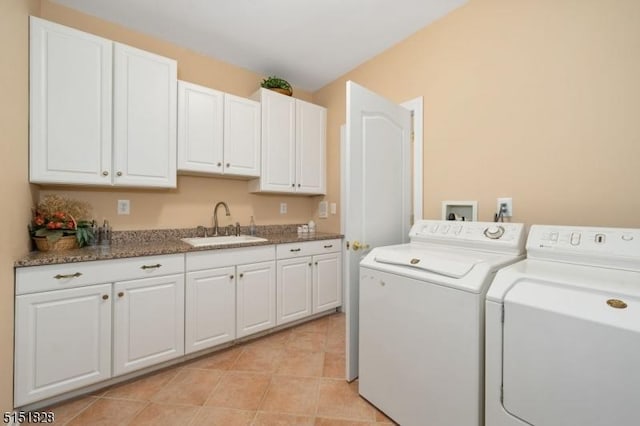 clothes washing area featuring cabinet space, light tile patterned floors, a sink, and independent washer and dryer