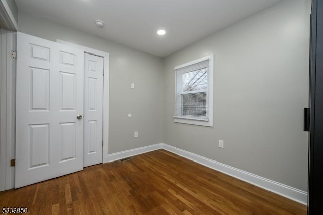 unfurnished bedroom featuring recessed lighting, baseboards, and wood finished floors