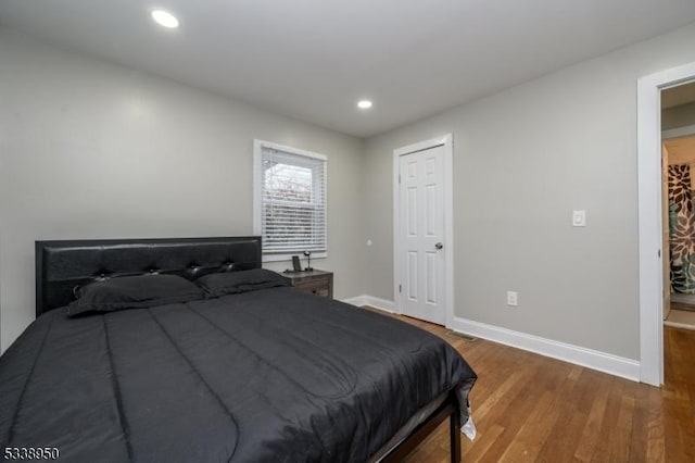 bedroom featuring recessed lighting, baseboards, and wood finished floors