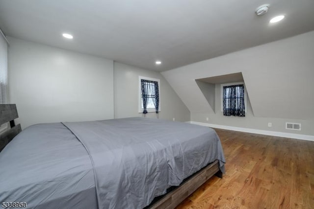 bedroom featuring recessed lighting, visible vents, and wood finished floors