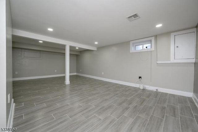 basement with recessed lighting, visible vents, light wood-style flooring, and baseboards