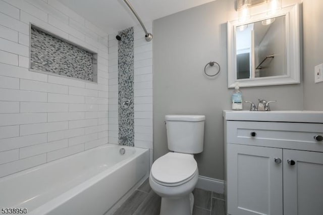 full bath with toilet, shower / washtub combination, vanity, and baseboards