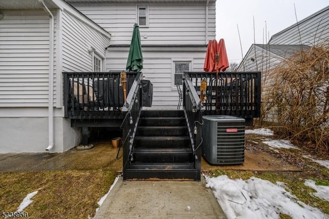 wooden terrace featuring central air condition unit and stairs