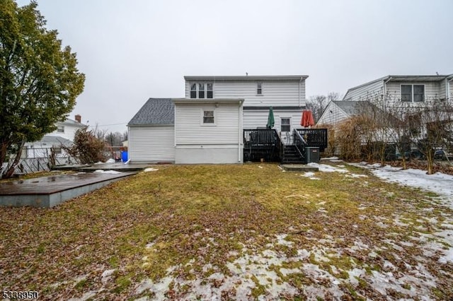 back of house featuring a deck and a yard