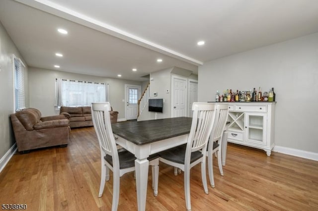 dining area featuring stairs, baseboards, light wood-style flooring, and recessed lighting