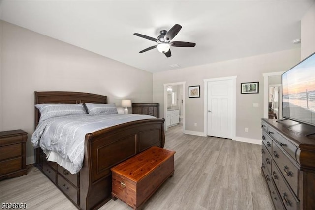 bedroom featuring light wood-style floors, baseboards, a ceiling fan, and ensuite bathroom