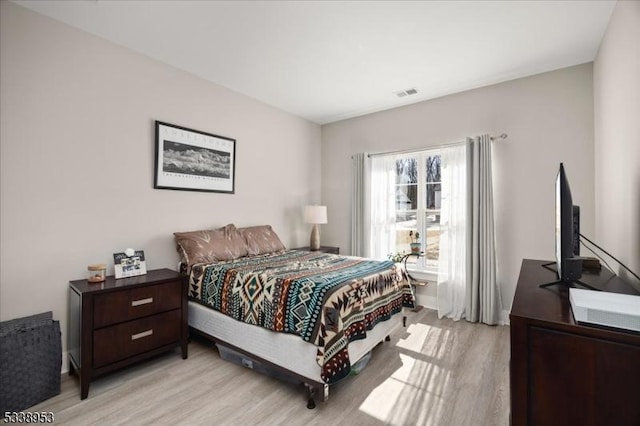 bedroom featuring visible vents and light wood-style floors