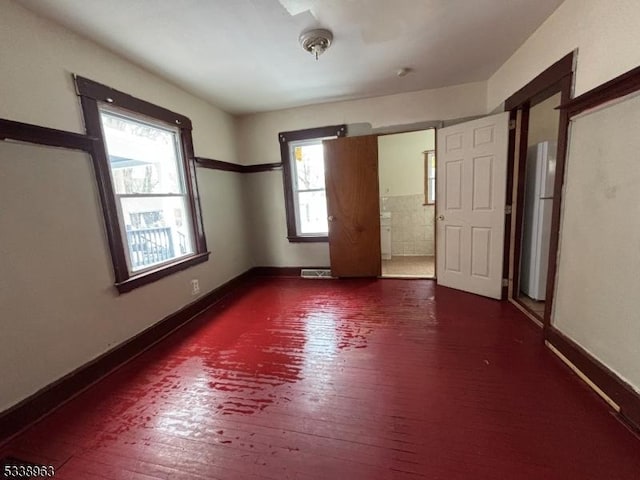 spare room with dark hardwood / wood-style flooring