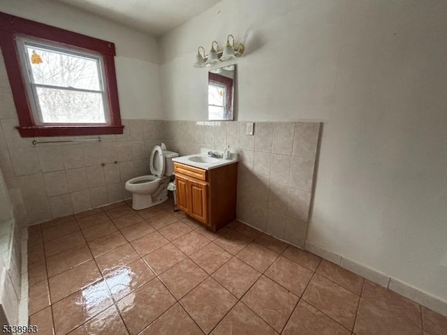 bathroom with vanity, tile patterned flooring, and a healthy amount of sunlight