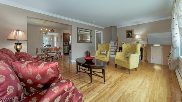 living area featuring crown molding, baseboards, light wood finished floors, and a chandelier