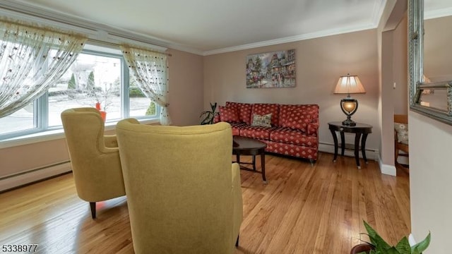 living area featuring light wood-style flooring, a baseboard heating unit, baseboards, and ornamental molding