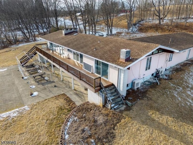 view of front of house with stairs and roof with shingles