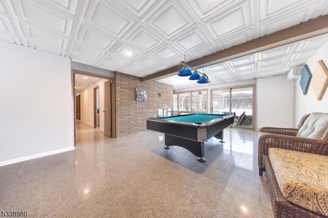 recreation room featuring billiards, baseboards, brick wall, an ornate ceiling, and light speckled floor