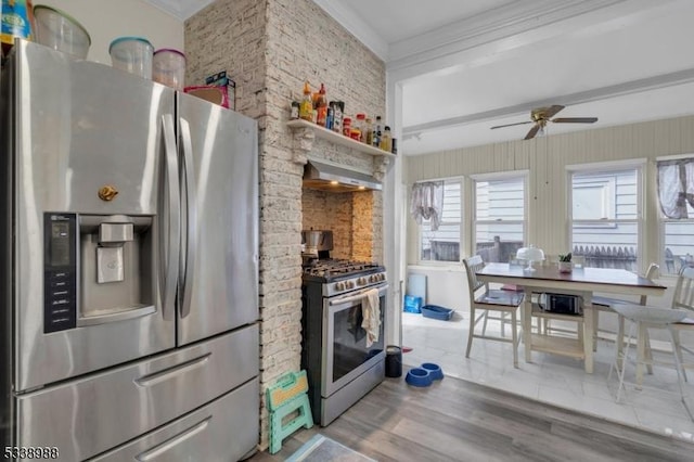 kitchen with stainless steel appliances, ornamental molding, ceiling fan, hardwood / wood-style floors, and wall chimney exhaust hood