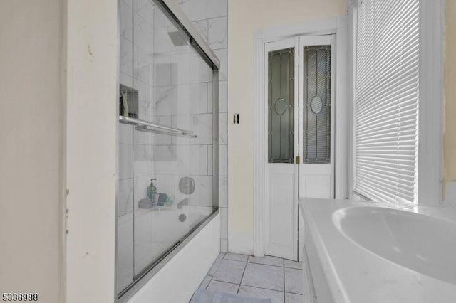 bathroom featuring shower / bath combination with glass door