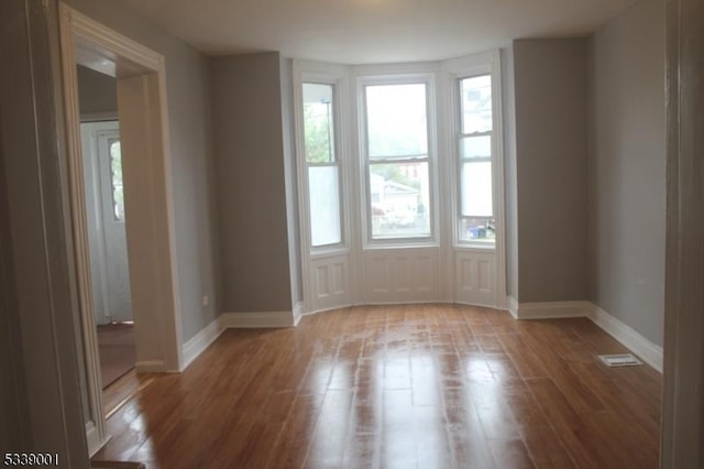 spare room with light wood-style flooring and baseboards