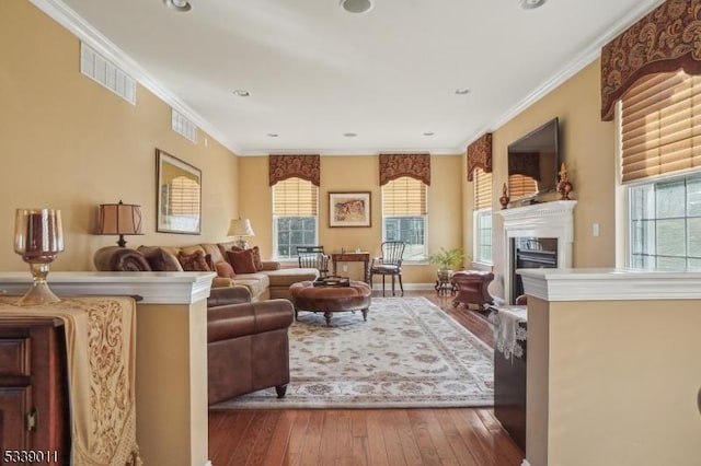 living room with ornamental molding and hardwood / wood-style floors