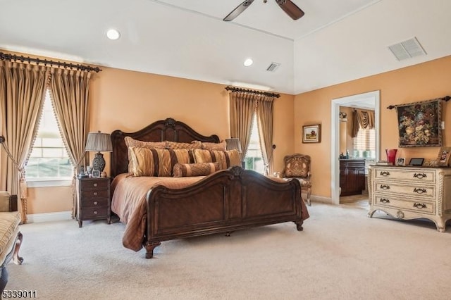 bedroom featuring light carpet, lofted ceiling, and ceiling fan