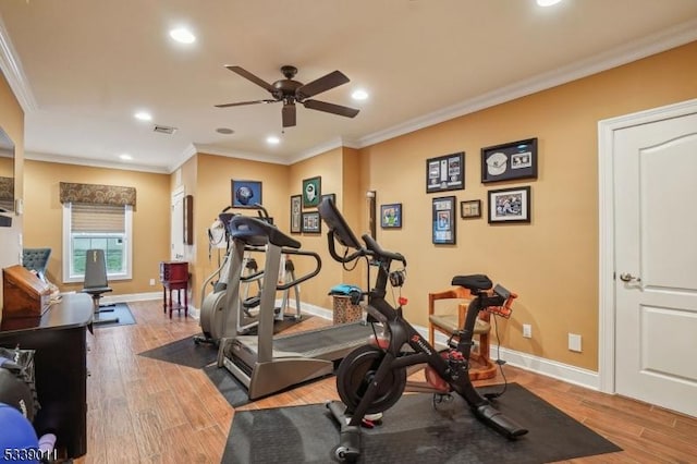 exercise room featuring ceiling fan, ornamental molding, and hardwood / wood-style floors