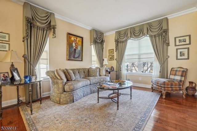 living area with ornamental molding and dark hardwood / wood-style floors