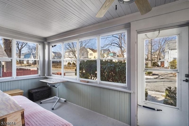 sunroom with a ceiling fan and a wealth of natural light