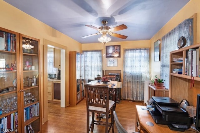 dining space featuring ceiling fan and wood finished floors