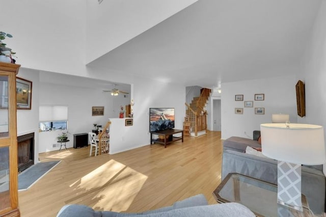60 Overlook Dr, Independence Twp, NJ 07840 - living room featuring stairway, light wood-style floors, a fireplace, and a ceiling fan
