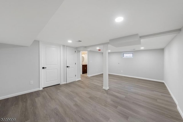 below grade area featuring recessed lighting, baseboards, and wood finished floors