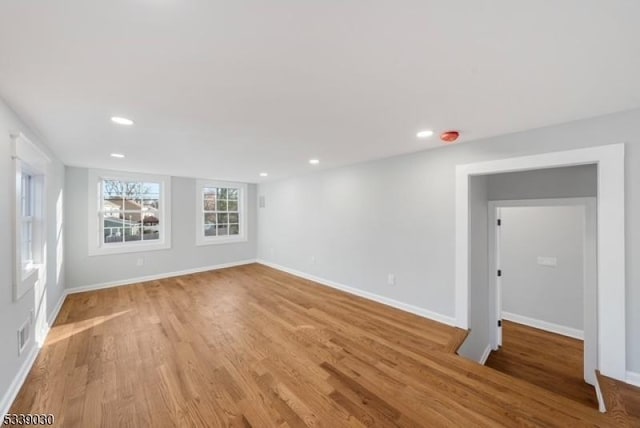 empty room featuring recessed lighting, visible vents, light wood-style flooring, and baseboards