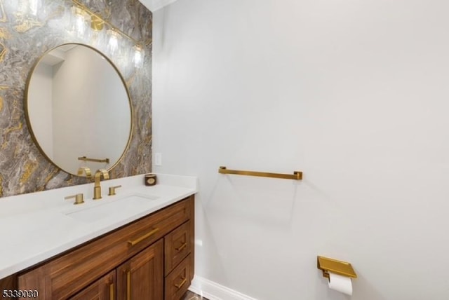 bathroom featuring baseboards and vanity