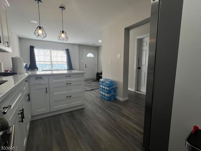 kitchen with baseboards, dark wood finished floors, white cabinets, hanging light fixtures, and light countertops