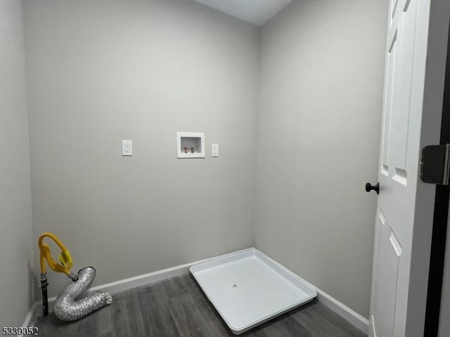 laundry area featuring dark wood-style flooring, laundry area, washer hookup, and baseboards