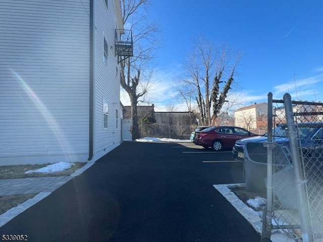 uncovered parking lot featuring fence