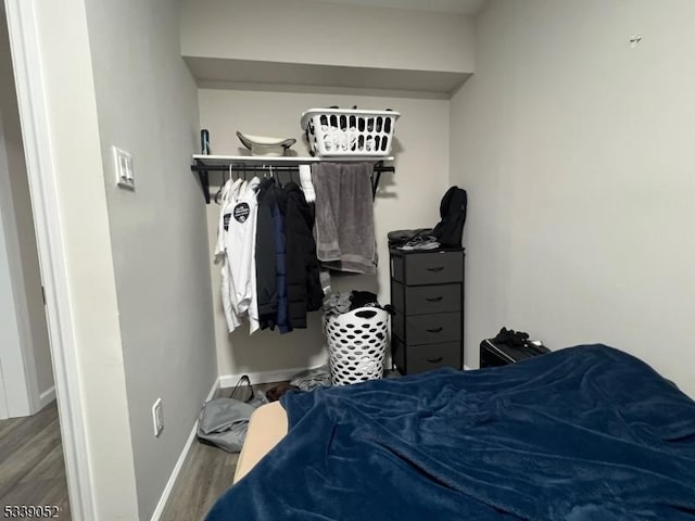 bedroom featuring baseboards and wood finished floors