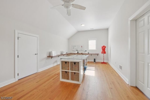 additional living space with lofted ceiling, baseboards, visible vents, and light wood finished floors