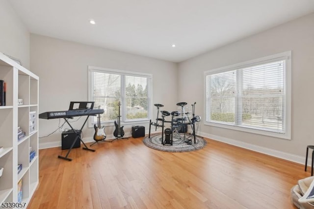 interior space featuring plenty of natural light, baseboards, wood finished floors, and recessed lighting