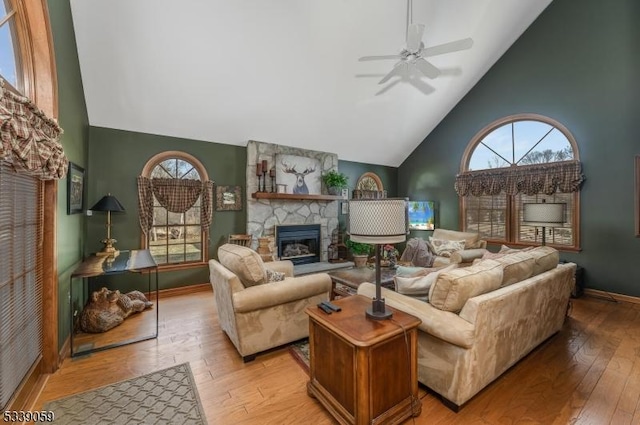 living area featuring high vaulted ceiling, a healthy amount of sunlight, and light wood-style floors