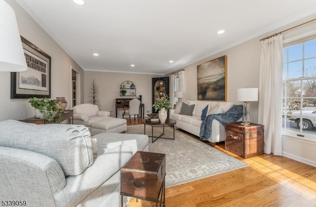 living area with recessed lighting, crown molding, and wood finished floors