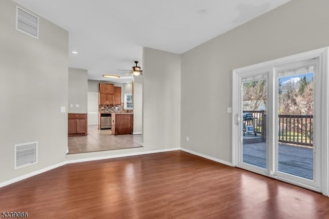 unfurnished living room featuring ceiling fan and light hardwood / wood-style flooring