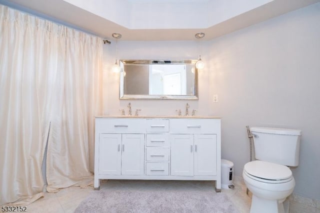 full bath featuring a sink, toilet, and double vanity