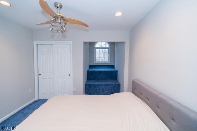 carpeted bedroom with ceiling fan, a closet, and baseboards