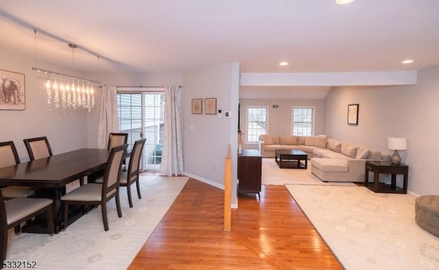 dining room with light wood finished floors, baseboards, a wealth of natural light, and recessed lighting