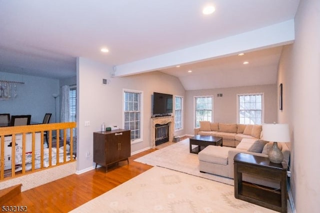 living room with recessed lighting, a fireplace, lofted ceiling with beams, and wood finished floors