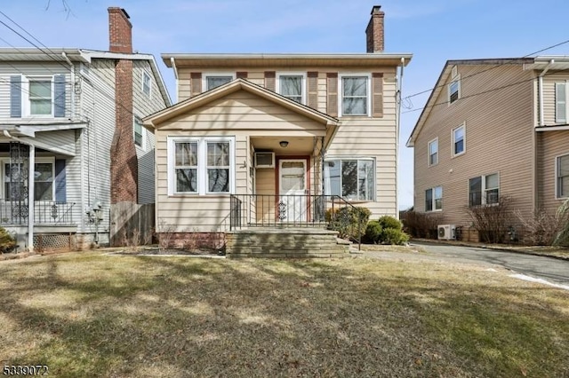 view of front of home featuring a chimney and a front lawn