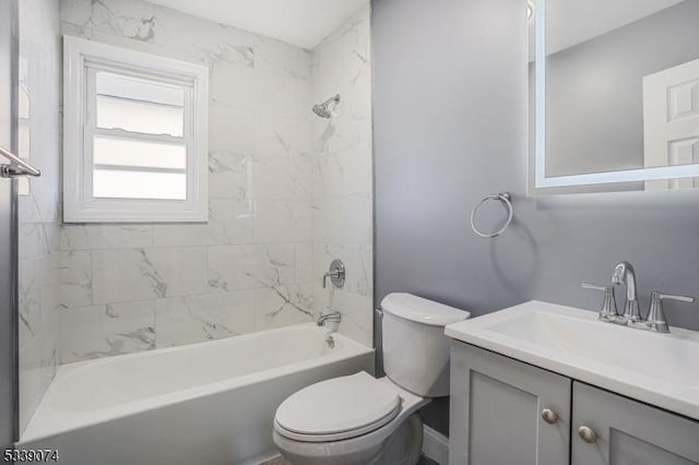 full bathroom with tiled shower / bath combo, toilet, and vanity