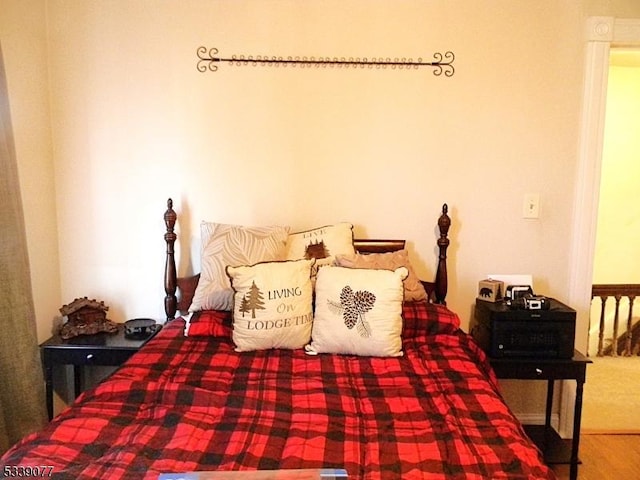 bedroom with wood finished floors