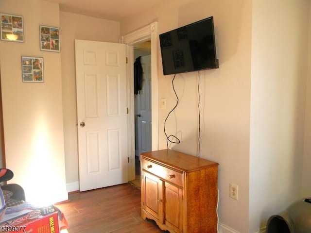 interior space featuring wood finished floors and baseboards